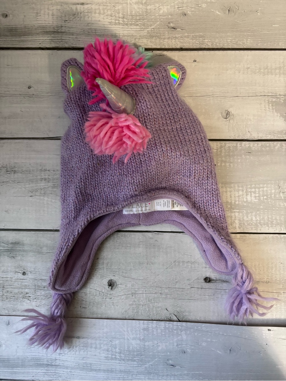 Place Lavender Unicorn Earflap Hat with Rainbow Pom Poms